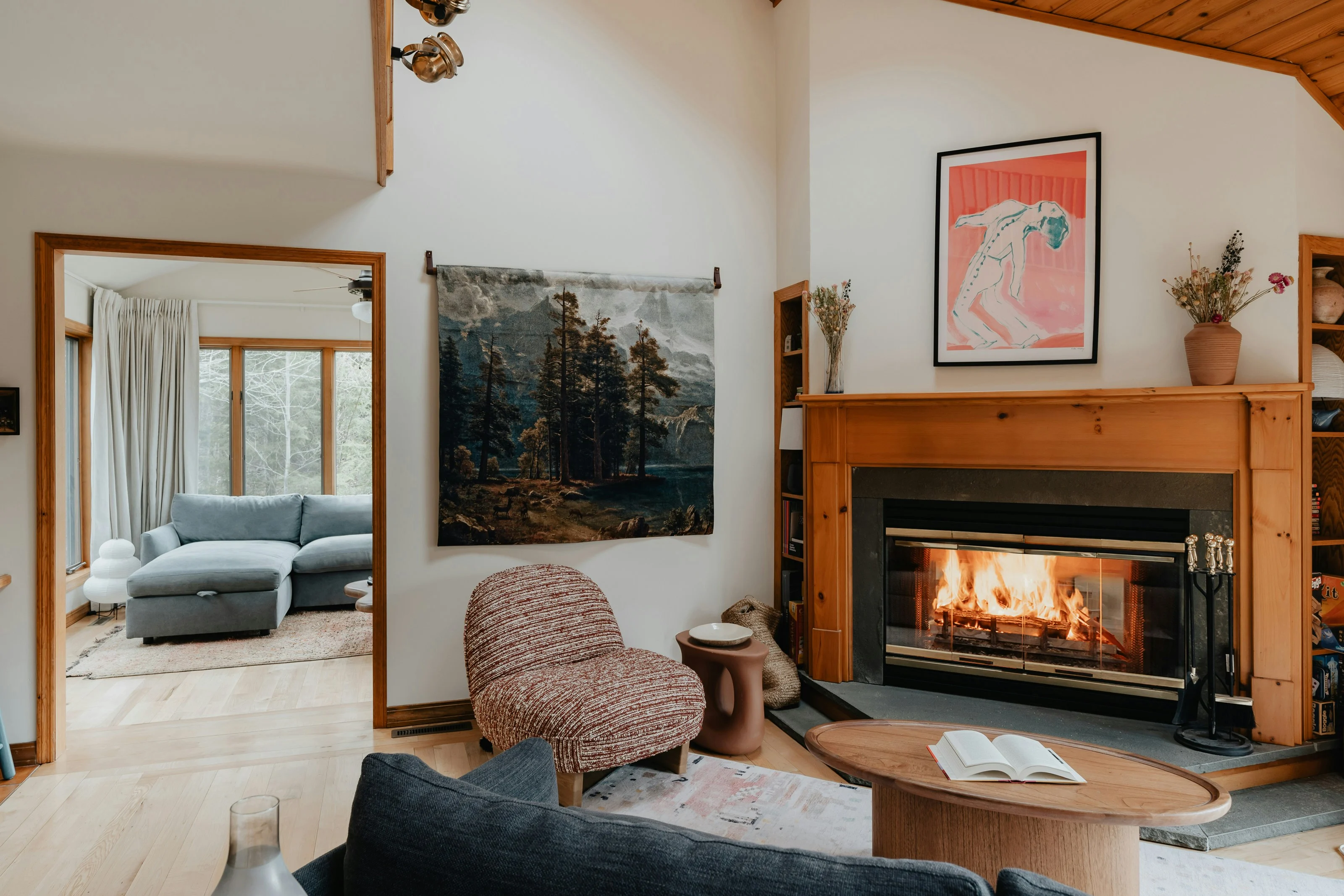 The lounge at dusk, lit by the fireplace