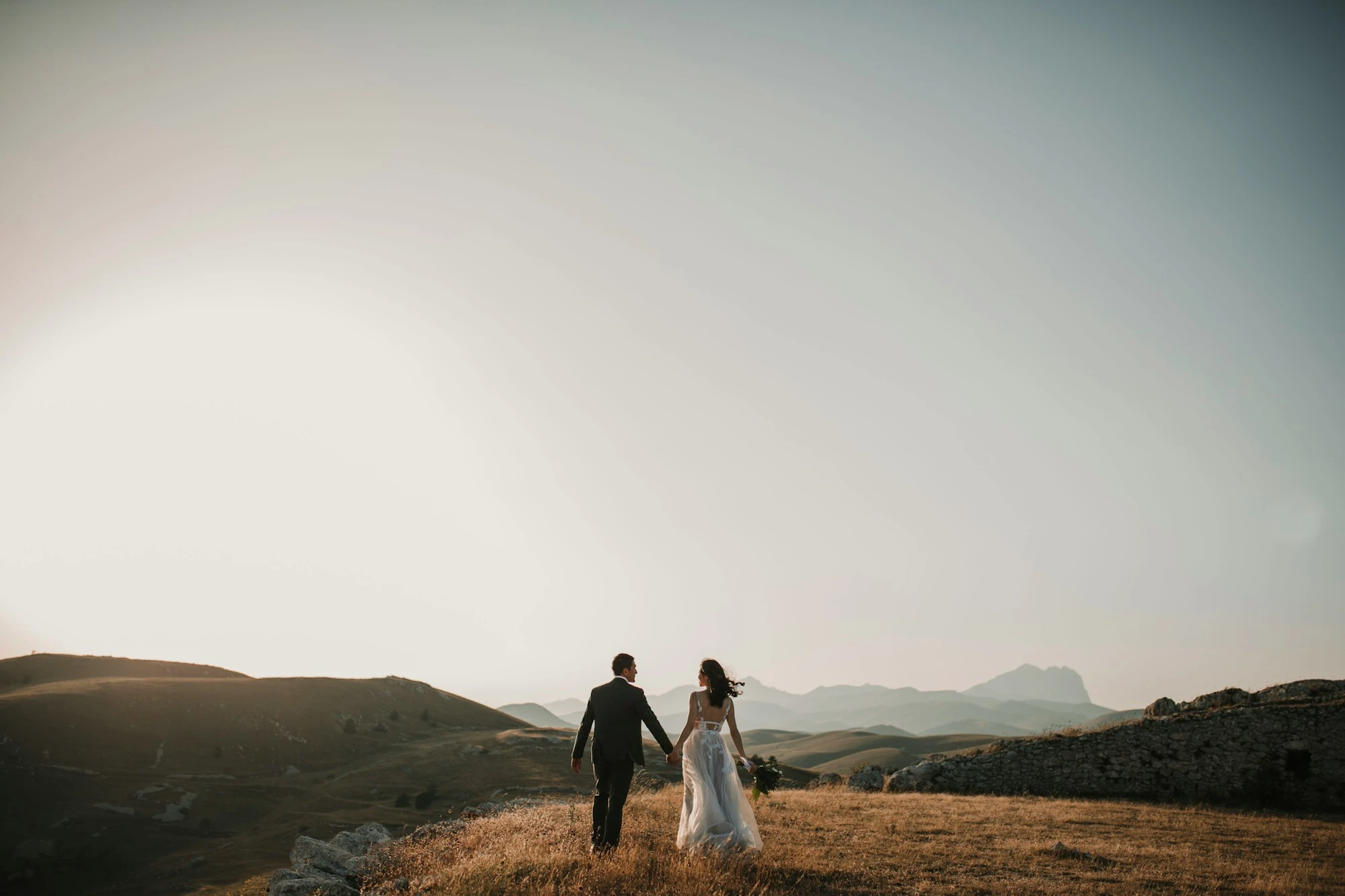 Lara & Stefan walking together at sunset