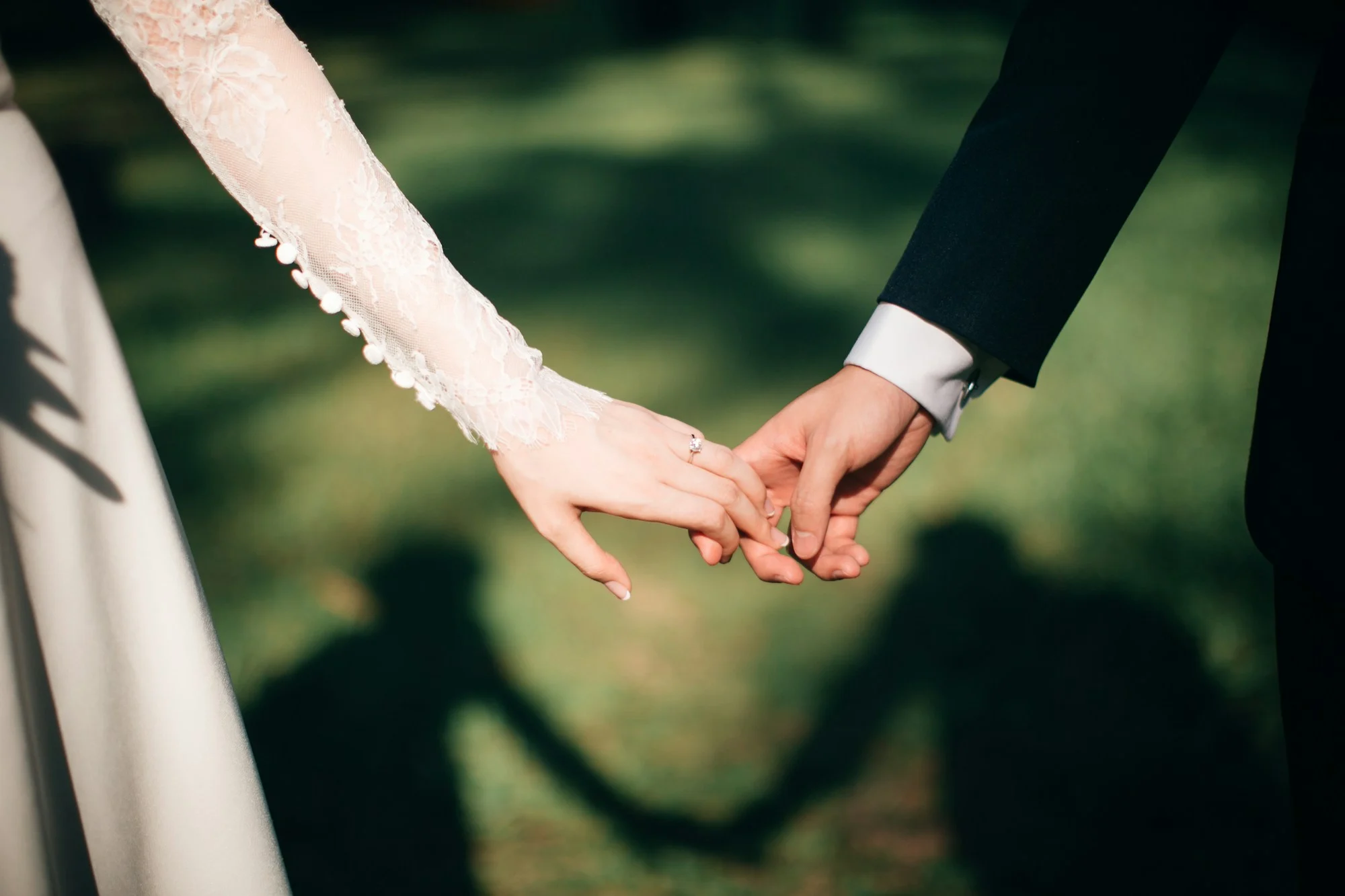 Hand in hand, the ring catching the light
