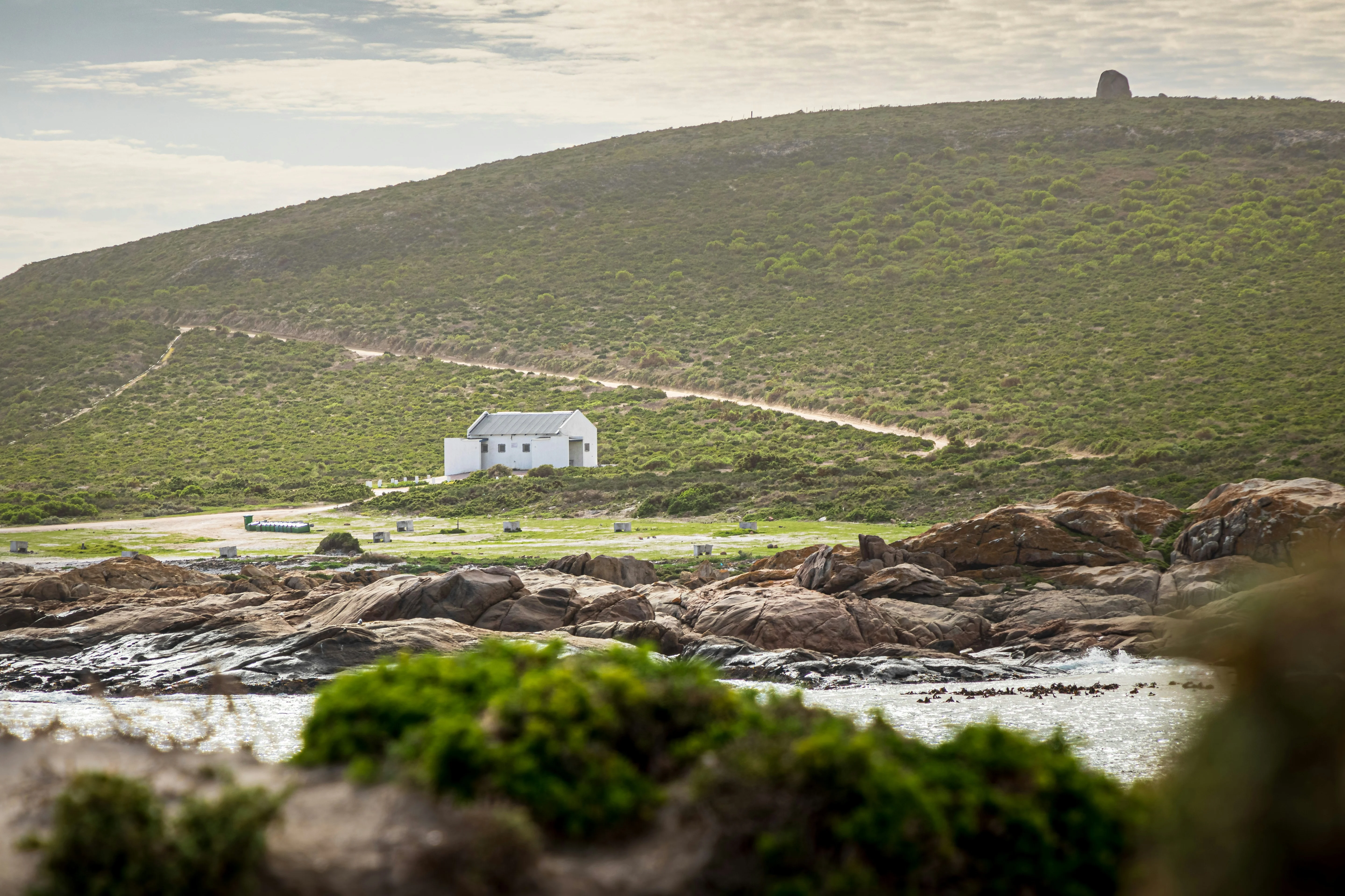 A house on a hill overlooking the water